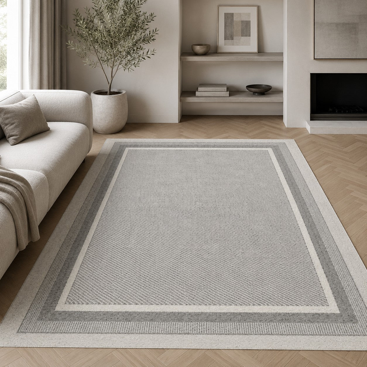 CarpetlyHome Bouclair szürke, keretes mintázatú modern polipropilén szőnyeg elegáns nappaliban.