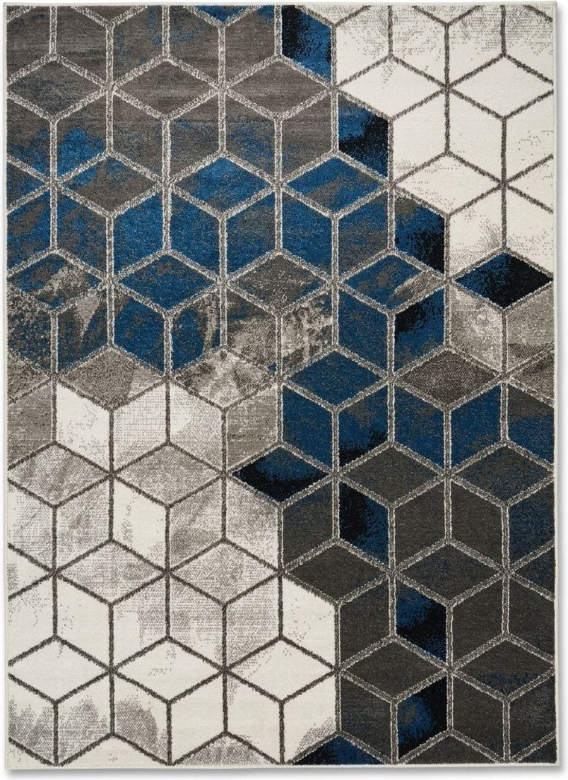 Téglalap alakú, modern szőnyeg kék, szürke és fehér árnyalatú, háromdimenziós hatású geometrikus kockamintával.